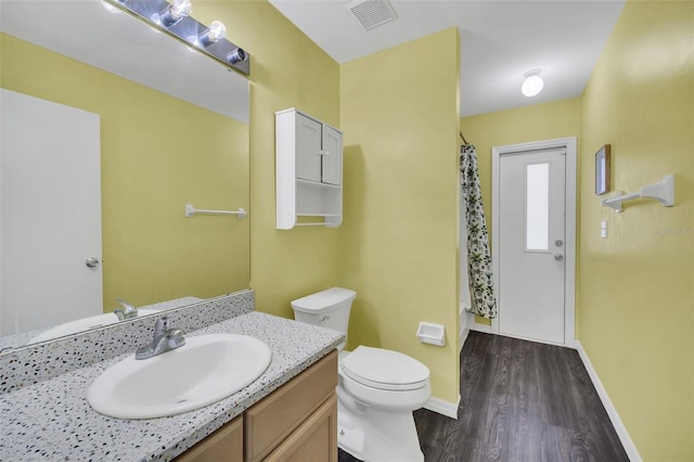 2204 Clementine Trl, Clermont, FL 34714 - bathroom with wood finished floors, vanity, toilet, baseboards, and a shower with shower curtain