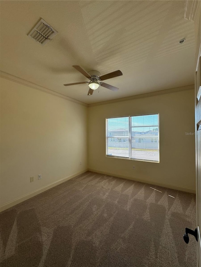 unfurnished room featuring crown molding, carpet floors, and ceiling fan