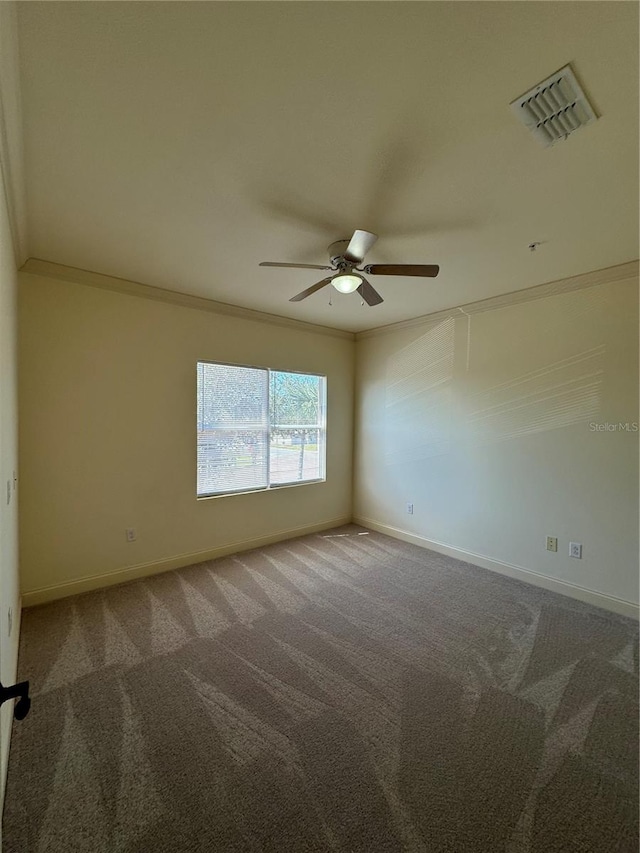 spare room with ceiling fan, carpet flooring, and ornamental molding