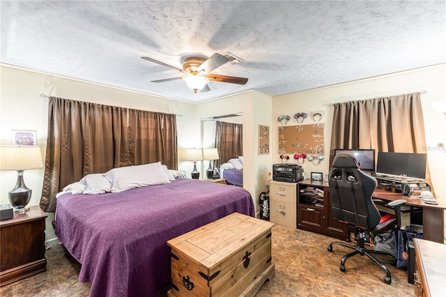 bedroom with a textured ceiling and ceiling fan