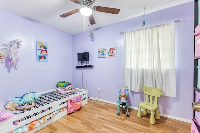 bedroom with light wood-type flooring and ceiling fan