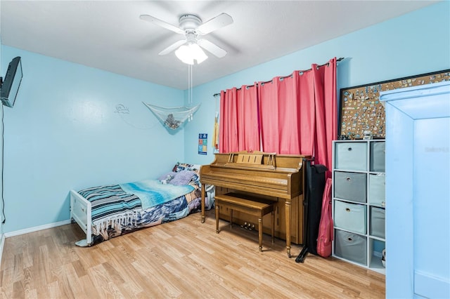 bedroom with wood-type flooring and ceiling fan