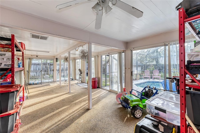 sunroom featuring ceiling fan and a healthy amount of sunlight