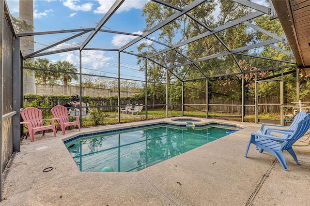 view of swimming pool with an in ground hot tub, a patio, and a lanai