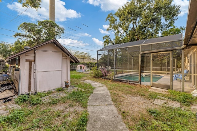 view of yard with a storage shed and a lanai