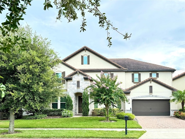 view of front of property featuring a garage and a front lawn