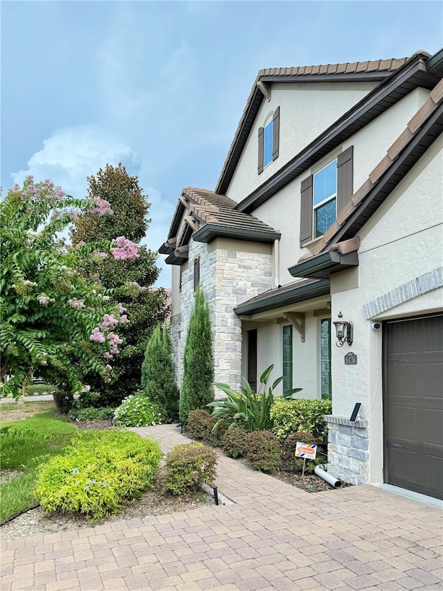 view of side of property with a garage