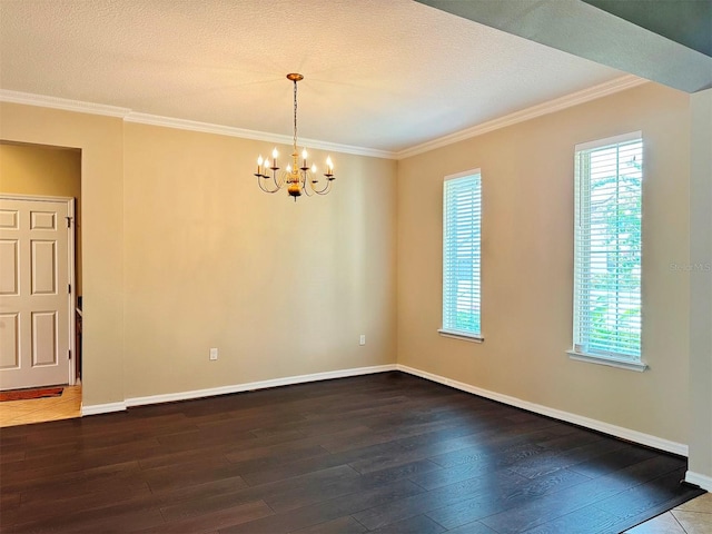 spare room with a textured ceiling, a notable chandelier, and hardwood / wood-style flooring