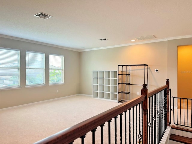 hall featuring a textured ceiling, carpet floors, and crown molding