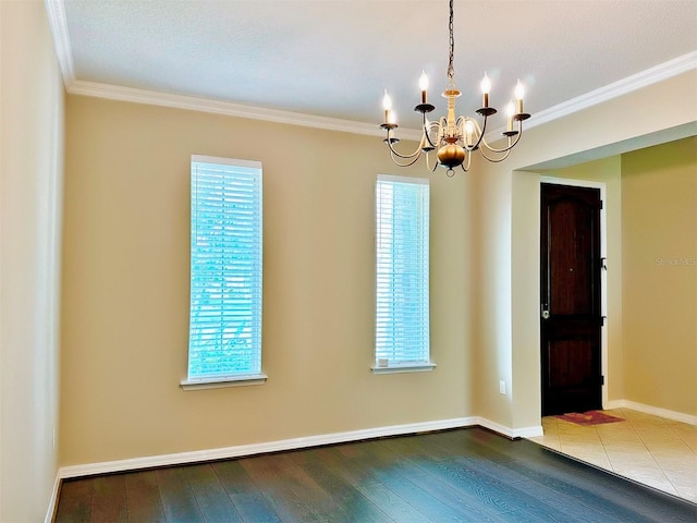 empty room featuring hardwood / wood-style flooring, plenty of natural light, and an inviting chandelier