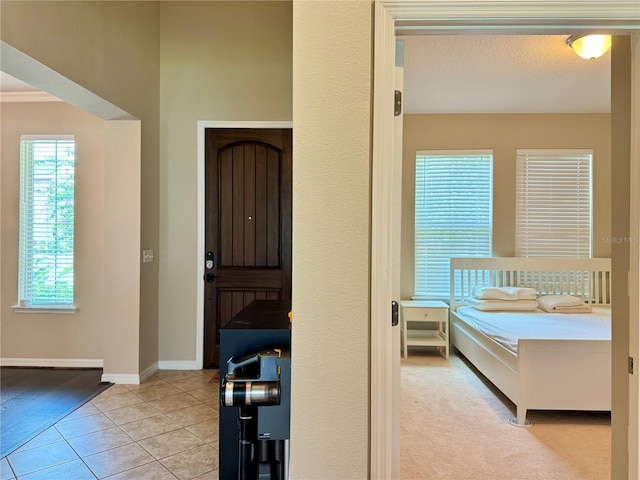 bedroom with light tile patterned floors and a textured ceiling