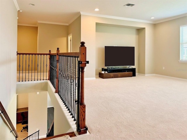 staircase with carpet floors and ornamental molding