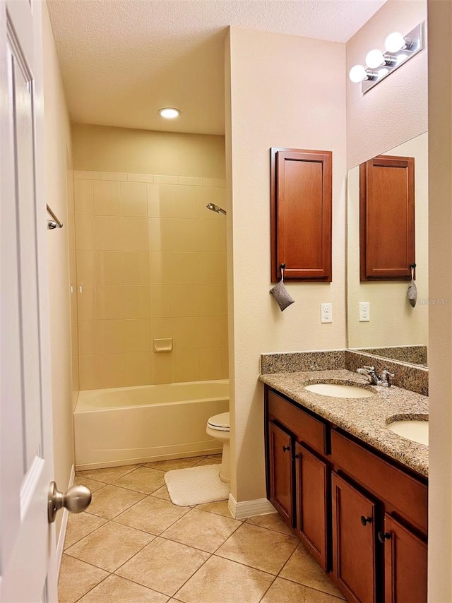 full bathroom featuring tile patterned flooring, vanity, toilet, and a textured ceiling