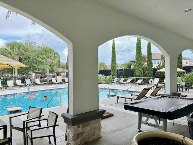 view of swimming pool featuring a patio area