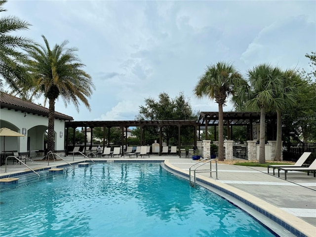 view of pool with a pergola and a patio area