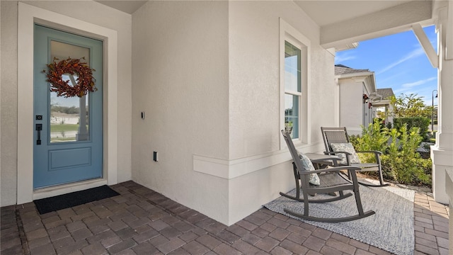 view of exterior entry with stucco siding