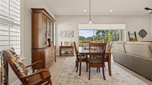 dining area featuring baseboards, light wood-type flooring, and recessed lighting