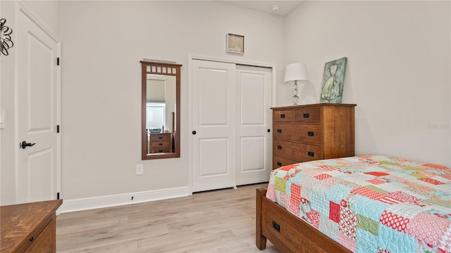 bedroom featuring light hardwood / wood-style flooring and a closet