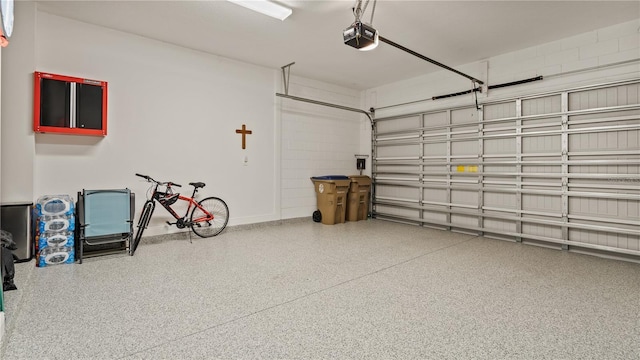 garage featuring baseboards and a garage door opener