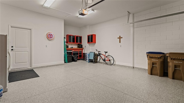 garage with a garage door opener and baseboards