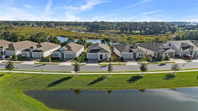 drone / aerial view featuring a residential view and a water view