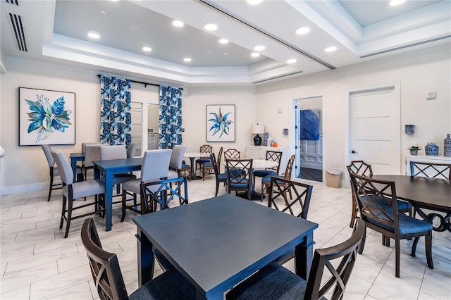 dining space with baseboards, recessed lighting, a raised ceiling, and marble finish floor