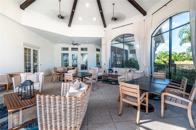 view of patio / terrace with an outdoor living space, fence, outdoor dining area, and a ceiling fan