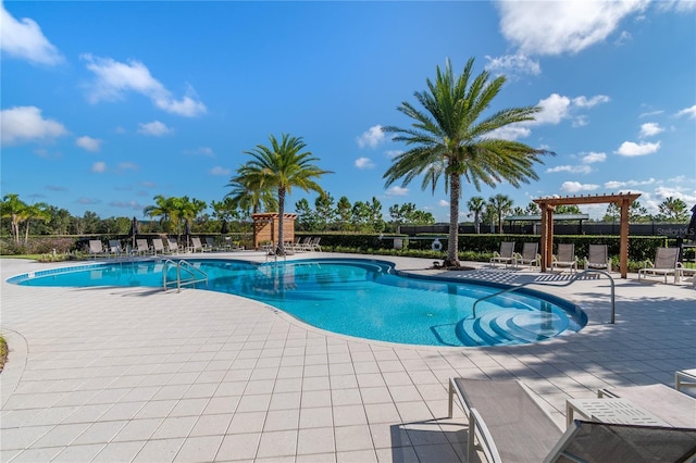 community pool with fence, a patio area, and a pergola
