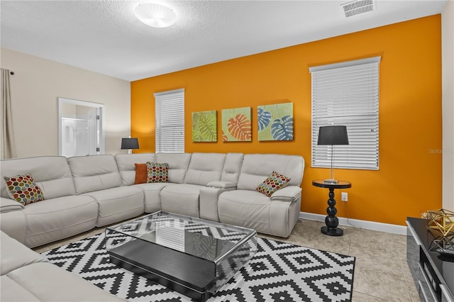 tiled living room with a textured ceiling