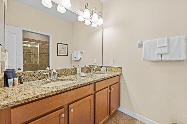 bathroom with tile patterned flooring, vanity, and a shower with door