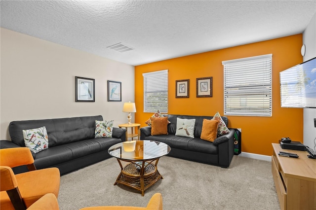 carpeted living room featuring a textured ceiling