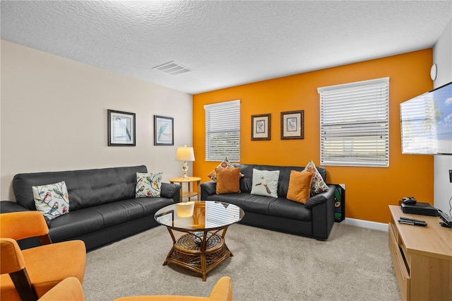 1473 Moon Valley Dr, Davenport, FL 33896 - living room with healthy amount of natural light, carpet floors, a textured ceiling, and baseboards