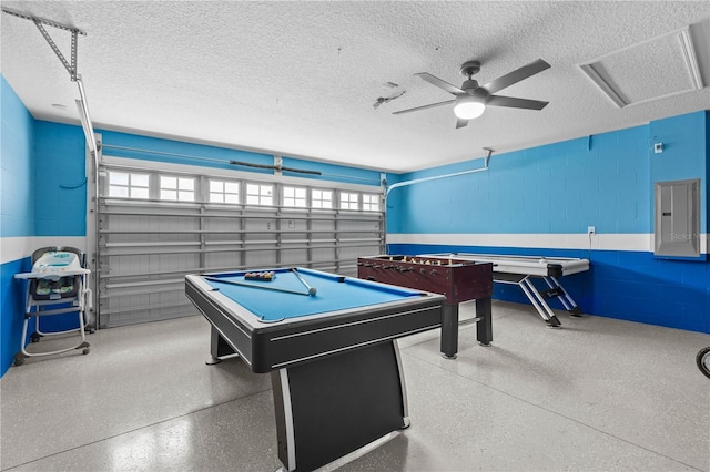 1473 Moon Valley Dr, Davenport, FL 33896 - rec room with electric panel, concrete block wall, a textured ceiling, speckle patterned floor, and a ceiling fan
