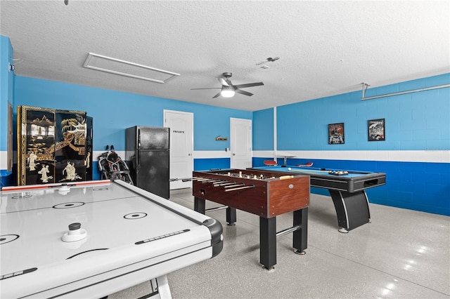 game room with ceiling fan and a textured ceiling