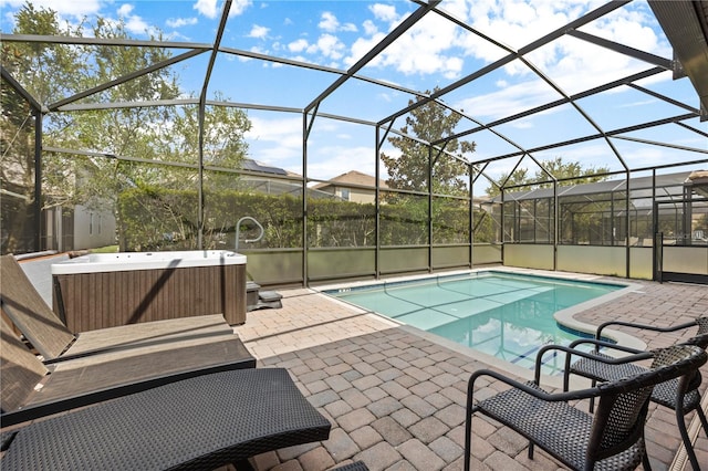 view of pool with a patio and glass enclosure