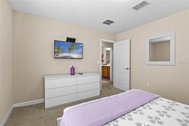 carpeted bedroom with a textured ceiling