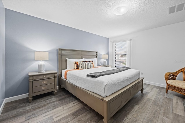 1473 Moon Valley Dr, Davenport, FL 33896 - bedroom with wood finished floors, a textured ceiling, and baseboards