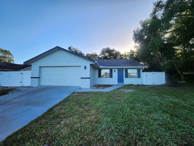 single story home with a garage and a lawn