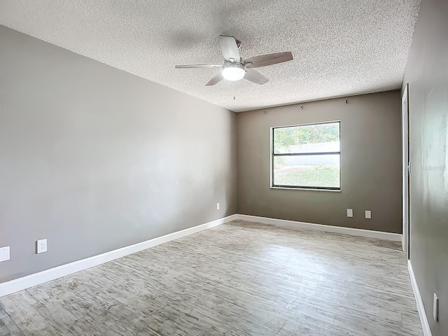 spare room with ceiling fan, a textured ceiling, and light hardwood / wood-style flooring