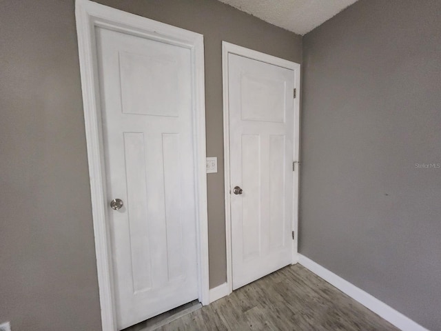 interior space with hardwood / wood-style flooring, a closet, and a textured ceiling