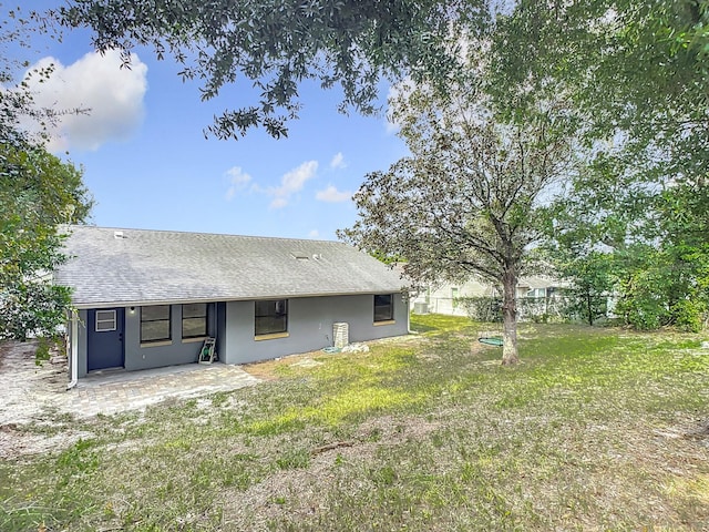 back of house featuring a patio and a lawn