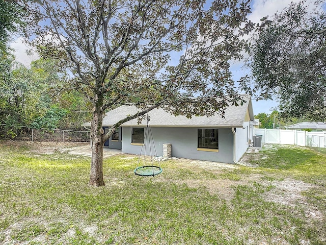 rear view of house with a yard