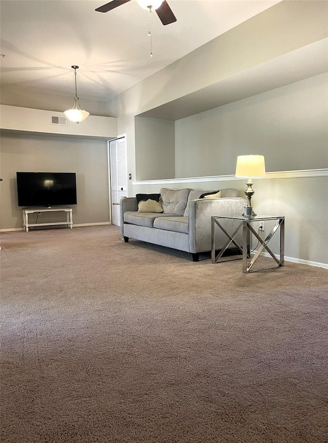 carpeted living room featuring ceiling fan