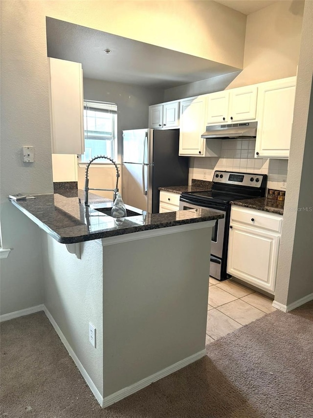 kitchen with white cabinets, kitchen peninsula, and stainless steel appliances