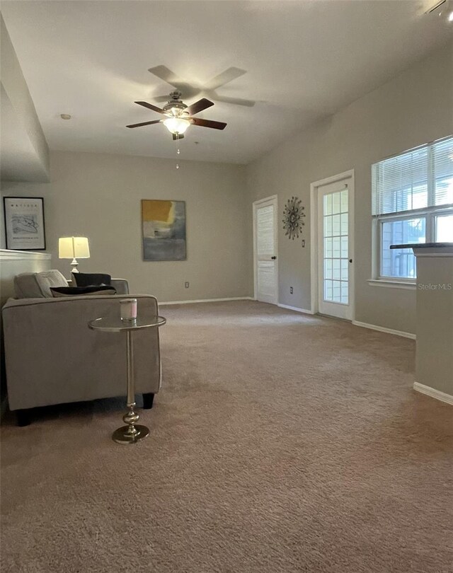 living room featuring carpet flooring and ceiling fan