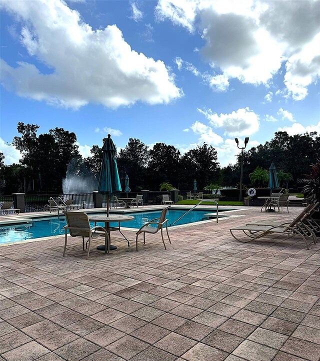 view of swimming pool featuring a patio area