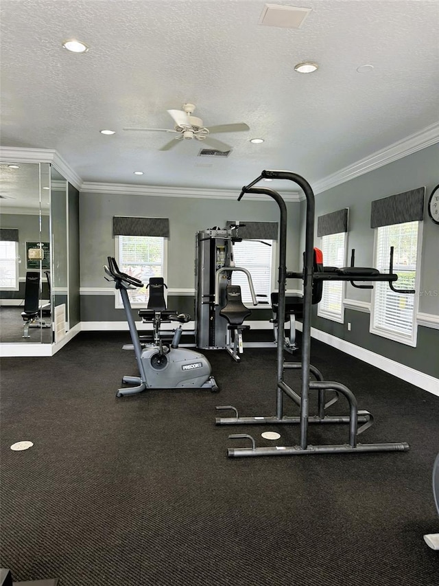 gym with ceiling fan, a textured ceiling, and crown molding