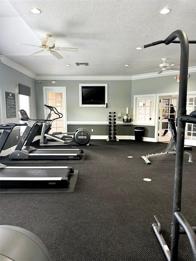 gym featuring ceiling fan, a textured ceiling, and ornamental molding