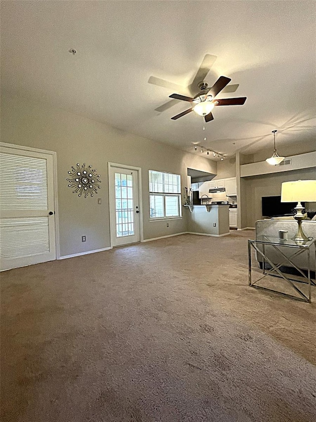 413 Summit Ridge Pl Unit 209, Longwood, FL 32779 - unfurnished living room featuring carpet flooring, ceiling fan, and baseboards
