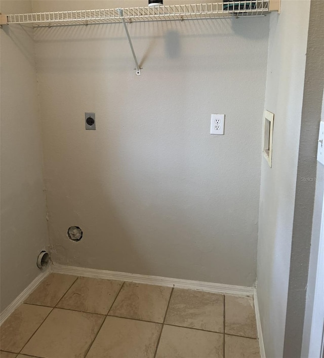 laundry area featuring hookup for an electric dryer and tile patterned flooring